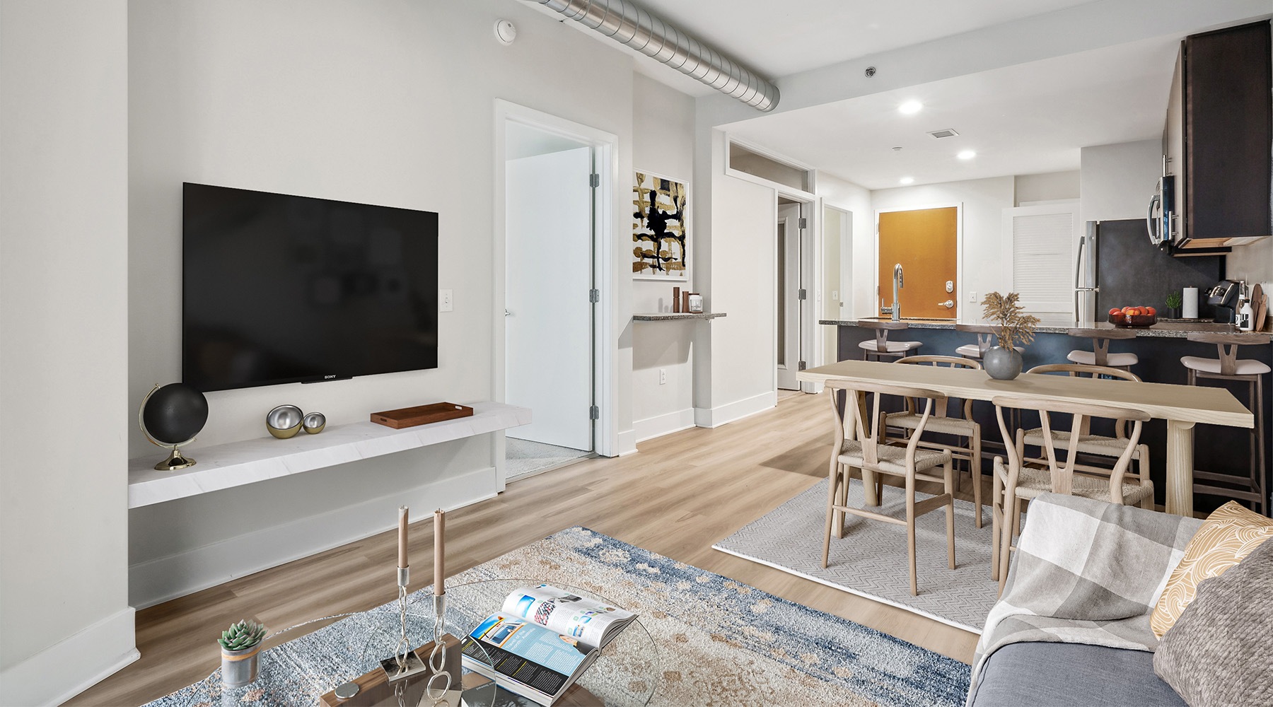 Living room and kitchen with granite countertops and kitchen island at AQ Rittenhouse luxury apartments in Philadelphia Living room and kitchen with granite countertops and kitchen island at AQ Rittenhouse luxury apartments in Philadelphia